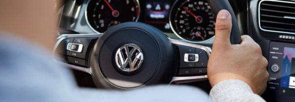 A close-up of a VW car steering wheel featured in a blog post about used vw cars