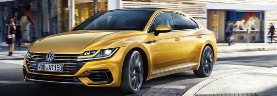 Gold 2019 Volkswagen Arteon turning street corner